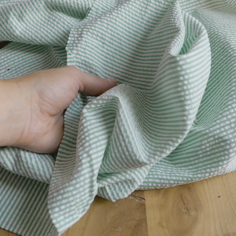 Green and white striped seersucker fabric.