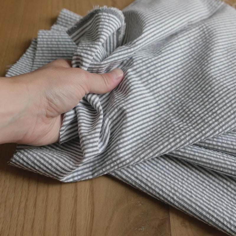 Black and white striped seersucker fabric.