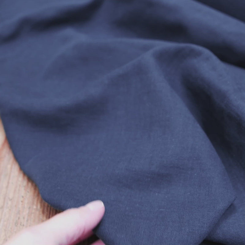 Navy blue fabric with a soft crumpled texture. 