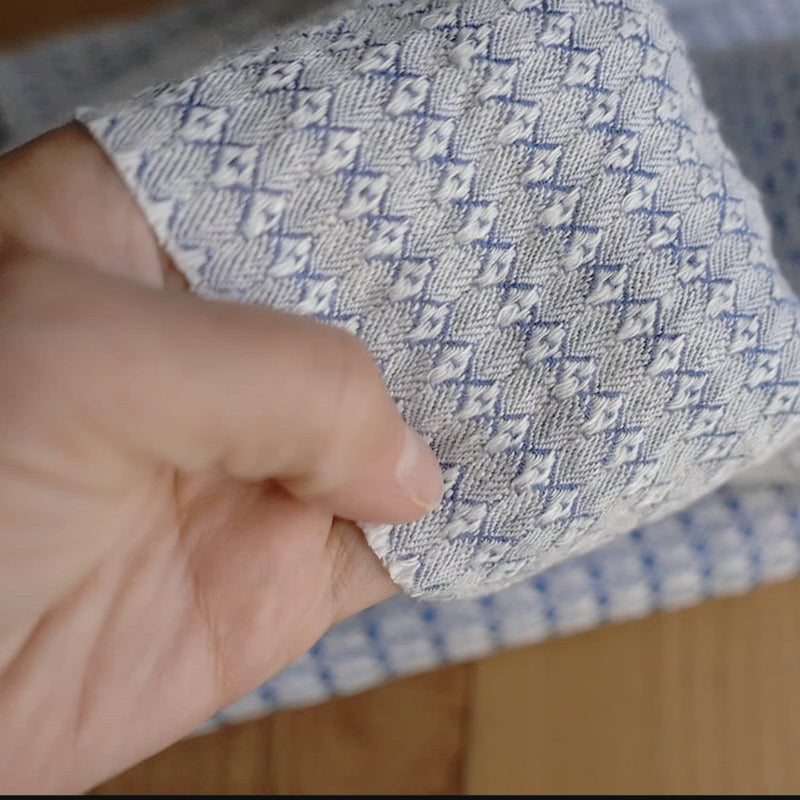 A black and white fabric woven in a honeycomb pattern.
