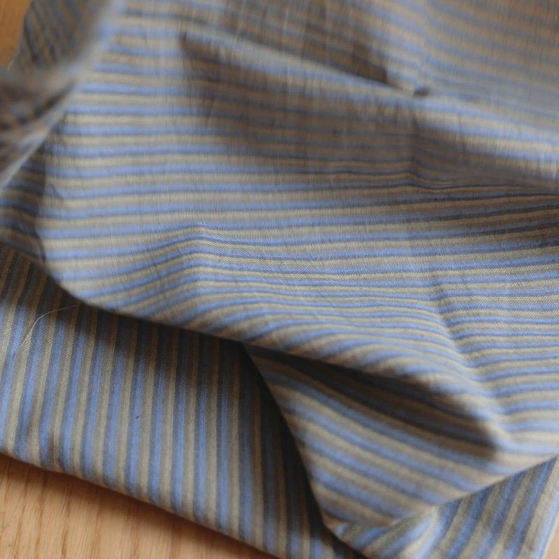 Grey fabric with a yellow and grey stripe. 