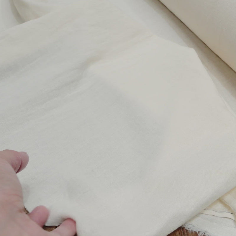Cream fabric with a soft crumpled texture. 