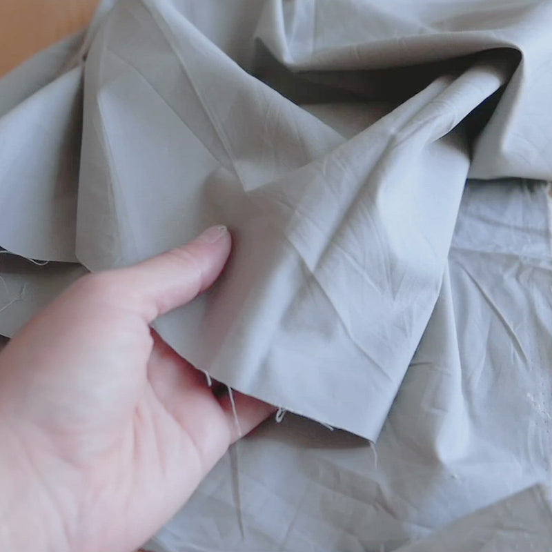 Plain, light grey fabric. 