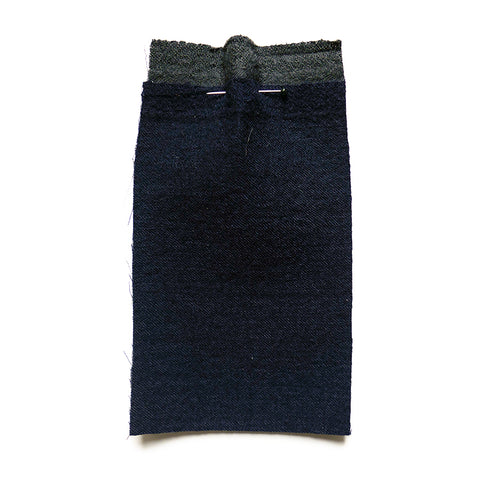 Navy blue wool fabric bonded to a dark grey wool fabric..