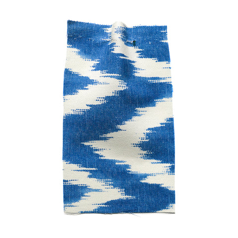 Blue fabric with a large cream chevron and a canvas texture. 