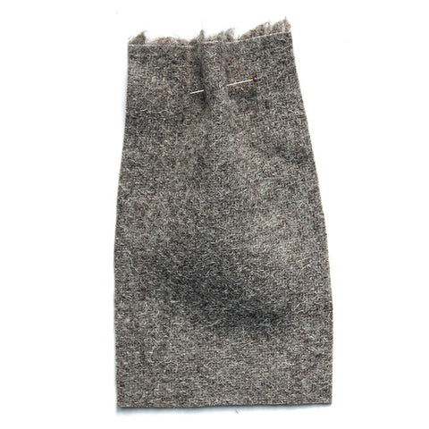 Grey fabric with a fibrous texture. 