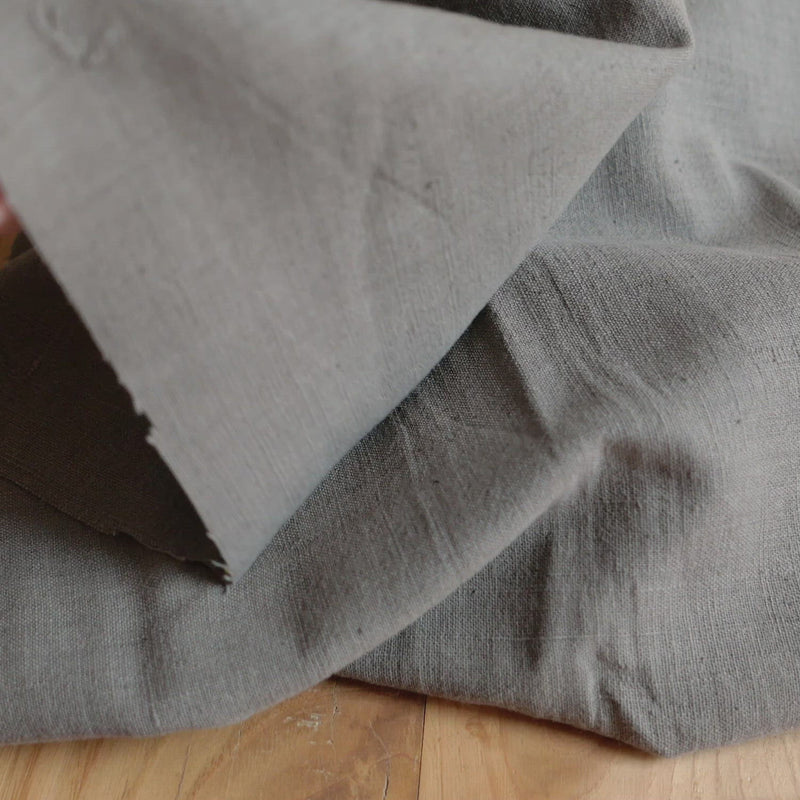 Grey fabric with a linen-like texture.
