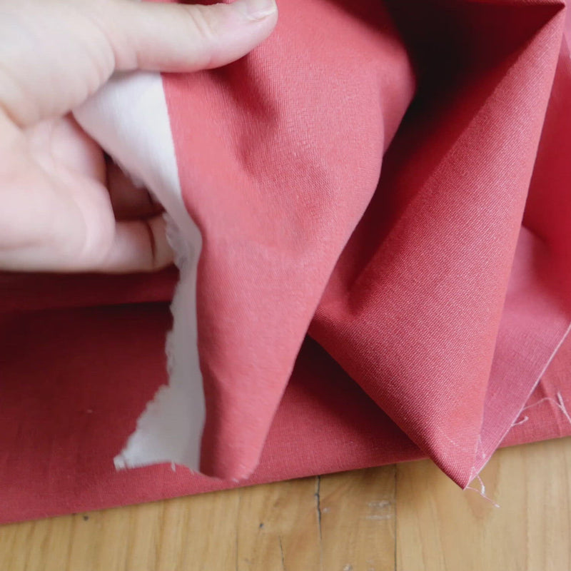 White canvas fabric painted with a coral dye.