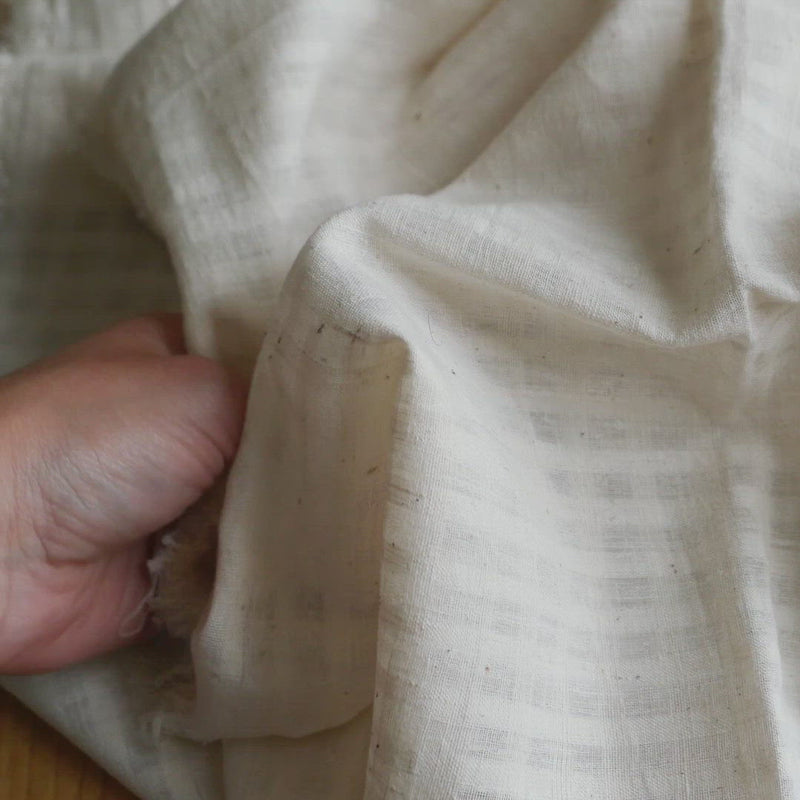 Cream fabric with a slubby texture and a self-check.
