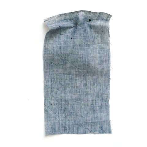 Grey chambray fabric with a washed and crumpled texture.