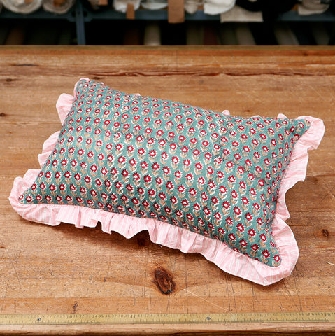 Quilted cushion with patterned cotton cover and pink frill.