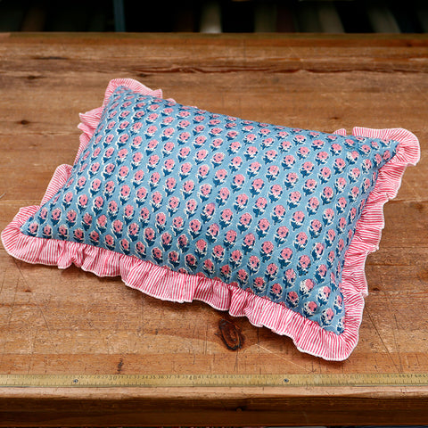 Quilted cushion with floral print and striped frill.