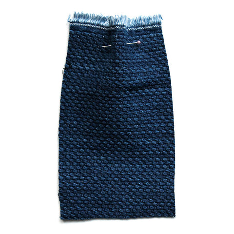 Indigo blue fabric with a chunky woven texture. 