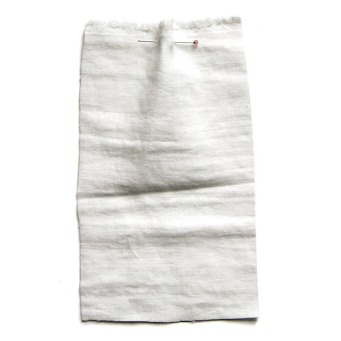 White fabric with a soft crumpled texture. 