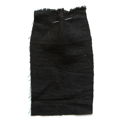 Black, wooly-looking fabric, with a twill weave.