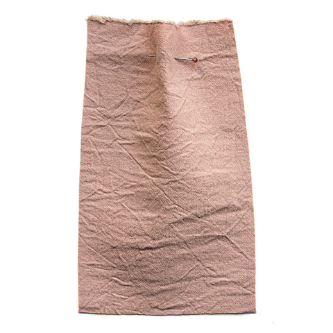 Plain pink fabric with a creased texture. 
