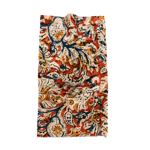 Printed floral fabric with an orange ground and multicoloured details.