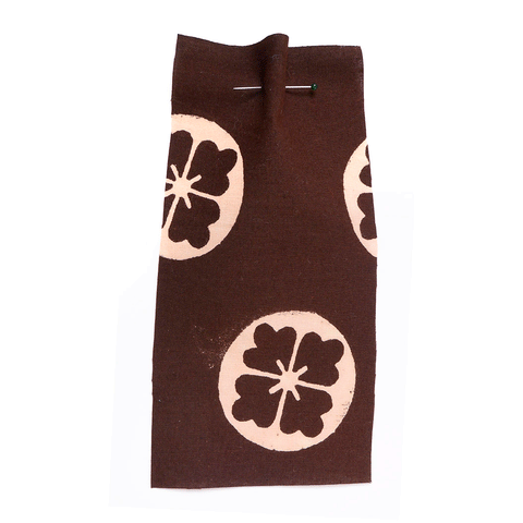 Brown cotton with a circular flower motif.