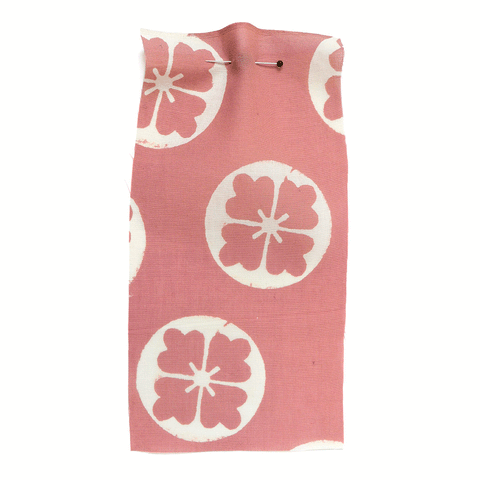 Pink cotton with a white flower motif.