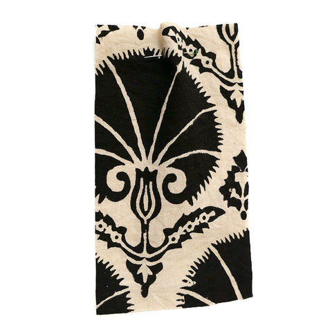 Cream fabric with a large scale floral motif in black. . 