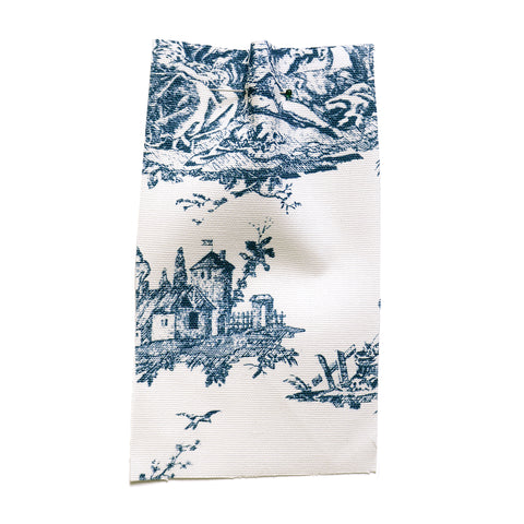 White cotton canvas printed with a blue farm scene pattern. 