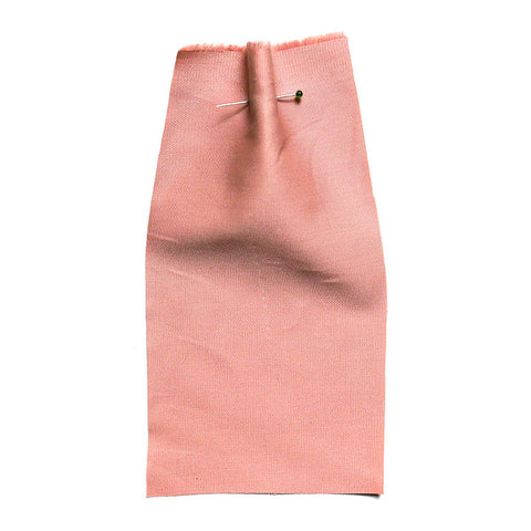 Plain pink fabric with a twill weave.