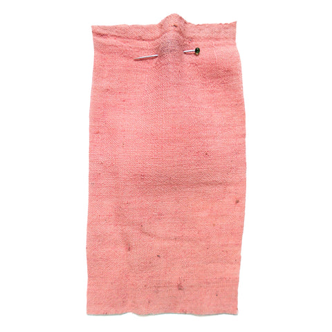 Pink fabric with a slubby texture.