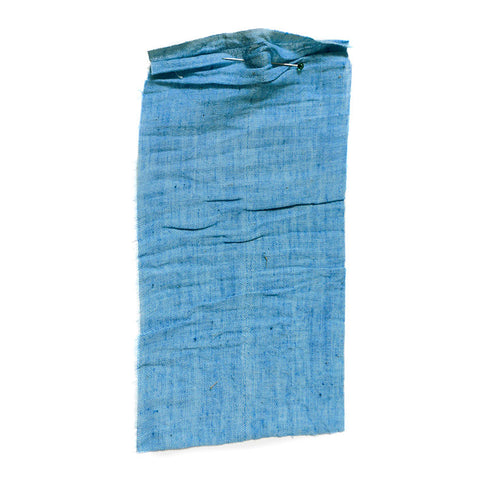 Bright blue chambray fabric with a washed and crumpled texture.