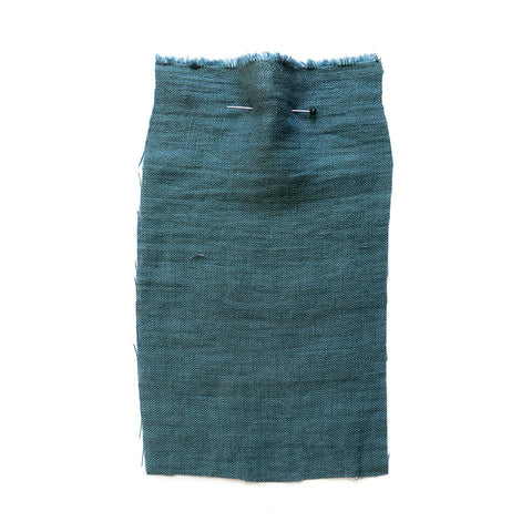 Blue fabric with a crumpled texture.