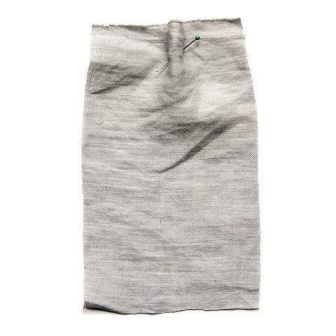 Pale grey fabric with a crumpled texture. 