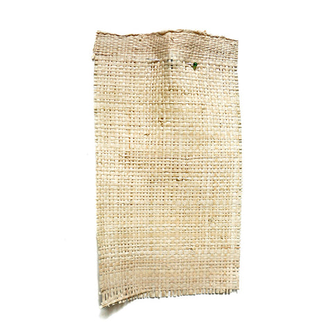Beige straw like fabric with a pronounced weave.
