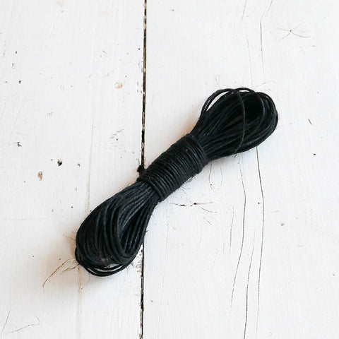 A skein of black linen string.
