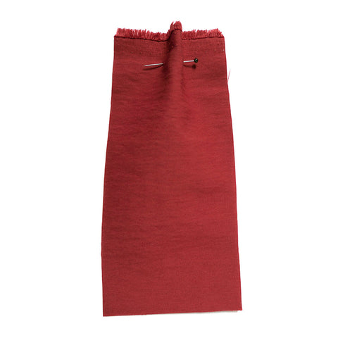 Red fabric with a faded quality. 