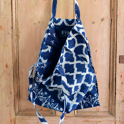 Indigo blue tote bag printed with contrasting patterns.