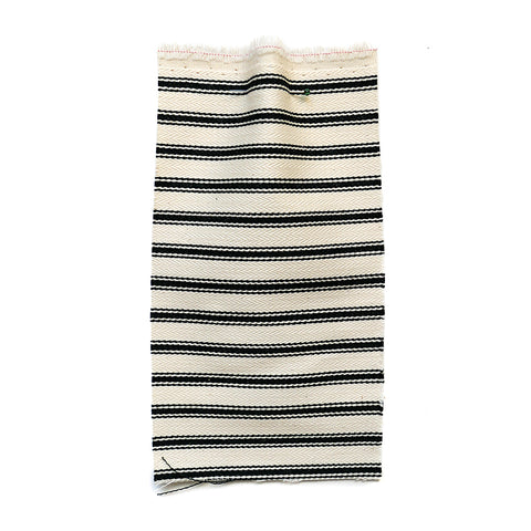 Cream herringbone fabric with a black ticking stripe.