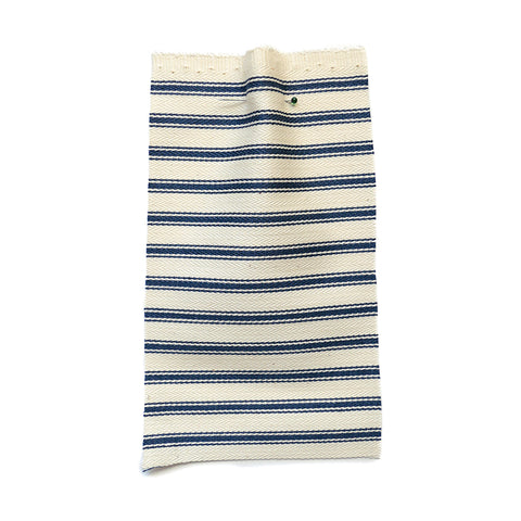 Cream herringbone fabric with a blue stripe.