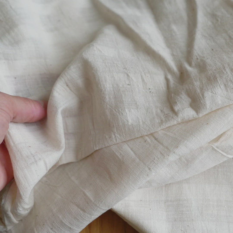 Cream fabric with a woven self check. 